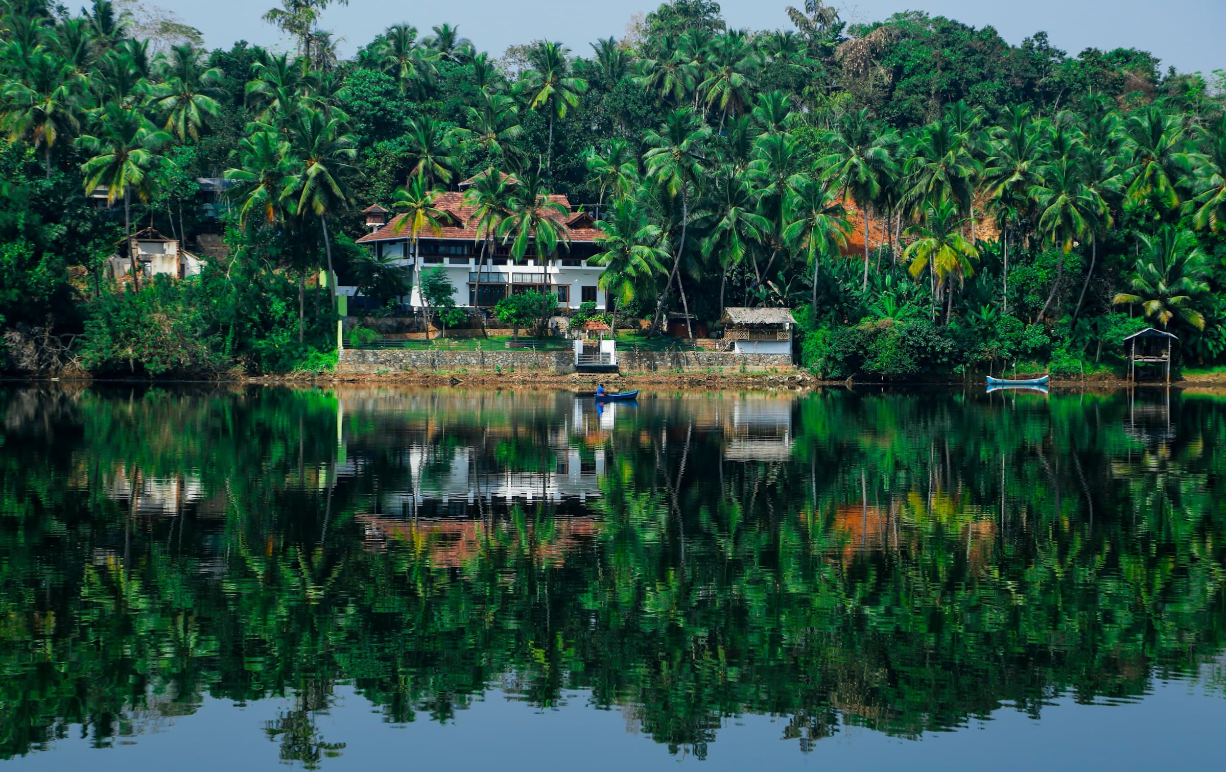 A house reflected in still backwaters